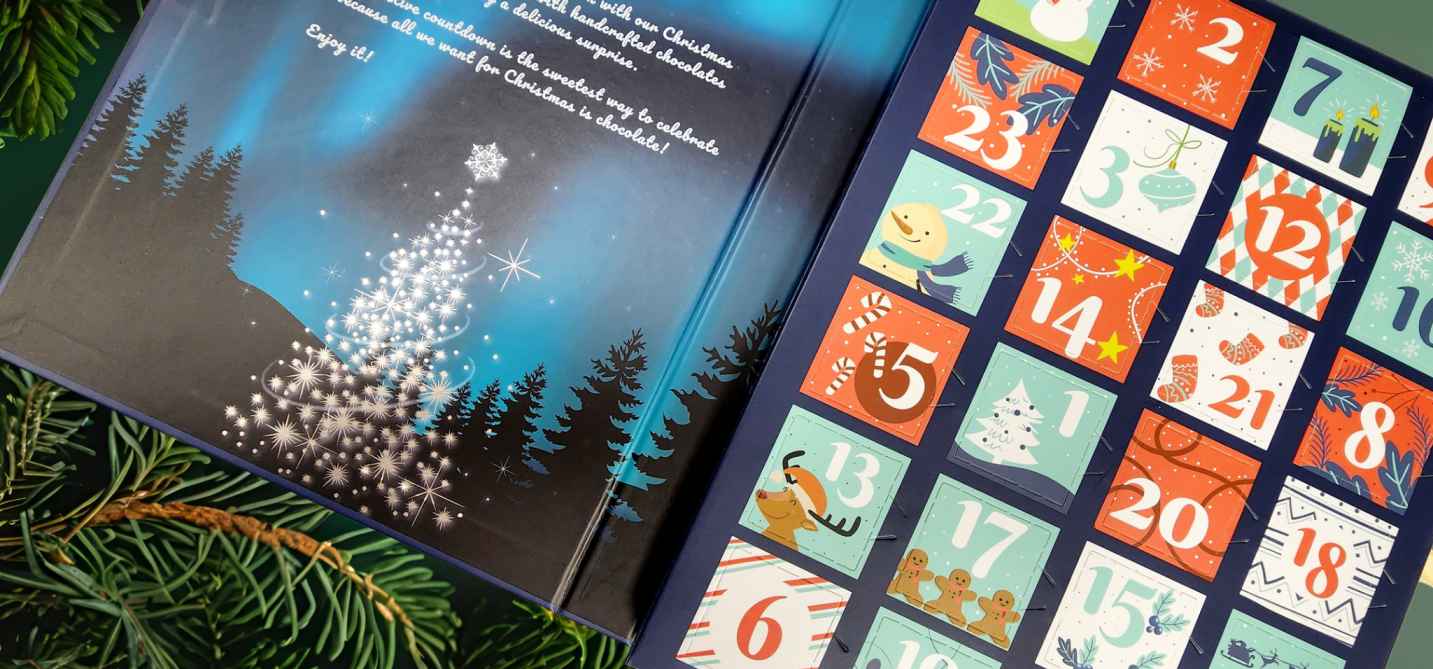 Advent calendar with numbered squares and Christmas-themed illustrations, surrounded by greenery.