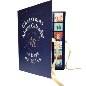 A Christmas advent calendar stands open, revealing numbered compartments and gold ribbons. The cover reads "Christmas Advent Calendar 24 Days of Bliss".