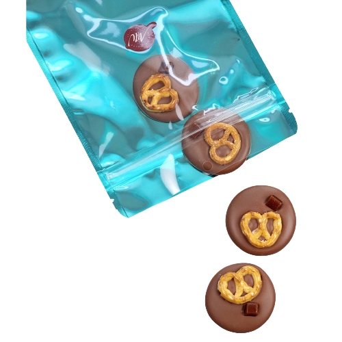 Cyan pouch with 4 milk chocolate disks topped with pretzel and a small piece of caramel 