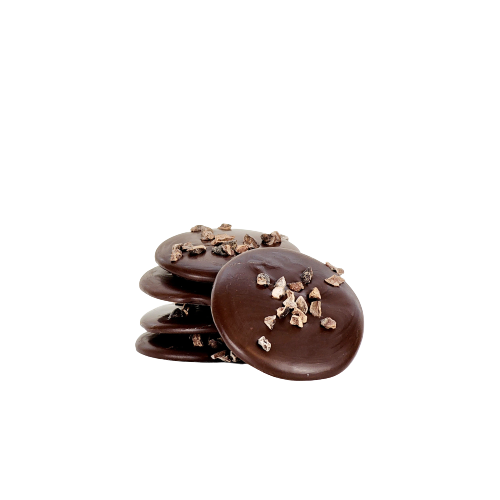 A pile of 5 dark chocolate disks topped with cocoa nibs