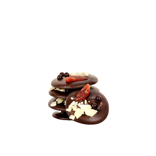 A pile of 5 dark chocolate disk stopped with dried strawberries almonds and dark chocolate balls